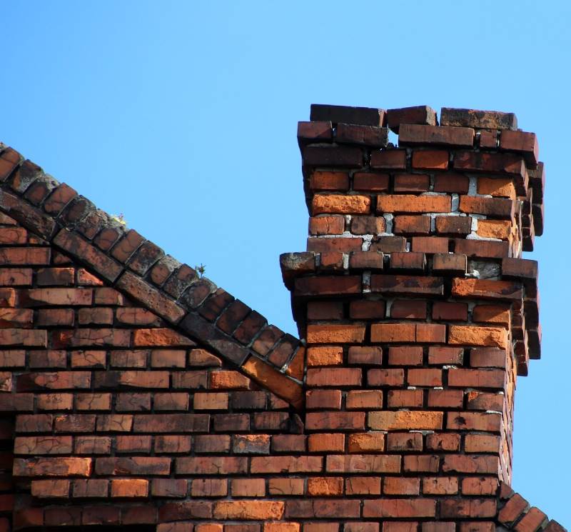 Signs Your Towson Home Needs a Chimney Inspection Damaged chimney on an Towson home showing cracks and missing mortar